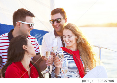 Smiling friends sitting on yacht deck 29307906