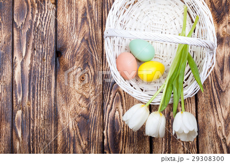 Easter Eggs in a white basket with white tulips 29308300