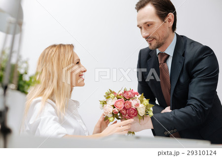 Cheerful businessman presenting gift to the 29310124