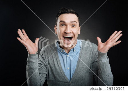 Happy young man holding hands in the air Happy young man holding hands in the air 29310305