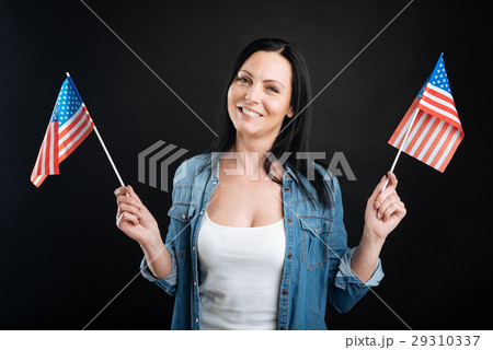 Happy looking girl holding American flags 29310337
