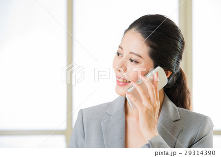 Business asian Woman talking on a Mobile phone Business asian Woman talking on a Mobile phone 29314390