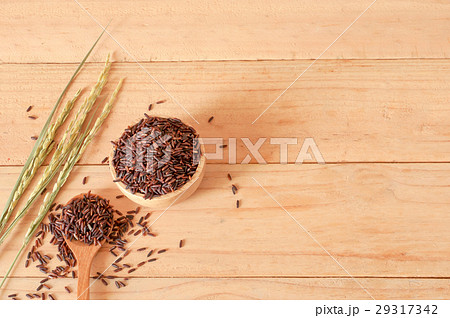 raw rice in bowl with  dried rice plant on wooden 29317342