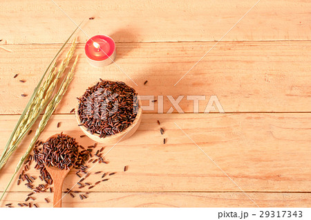 raw rice in bowl with  dried rice plant on wooden 29317343