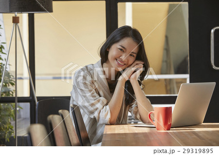 The woman looks very happy in the morming in the office 29319895