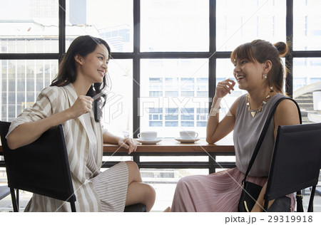 Two bussinesswomen are sitting in the office and discussing for work 29319918