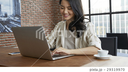 Portrait of beautiful woman working on laptop in office. Portrait of beautiful woman working on laptop in office. 29319970