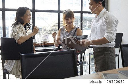 A portrait of teamwork where team members are discussing about work A portrait of teamwork where team members are discussing about work 29320032