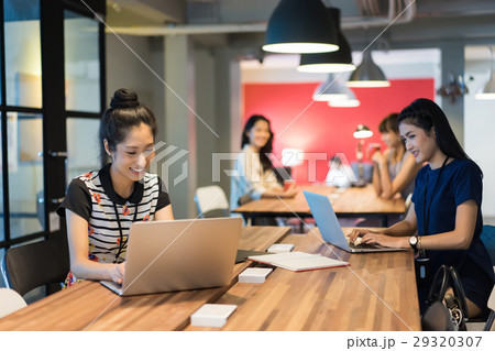 A group of office ladies working in a modern workplace 29320307