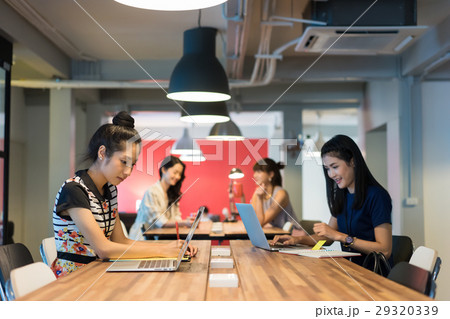 A group of office ladies working in a modern workplace 29320339