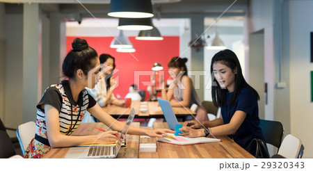 A group of office ladies working in a modern workplace 29320343