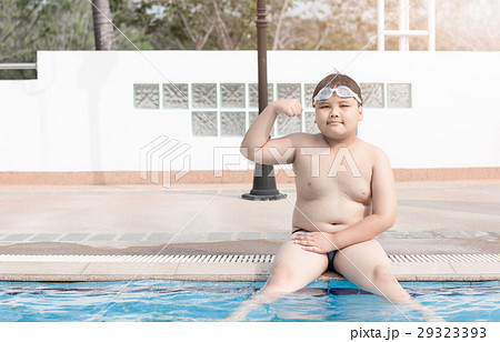 Obese fat boy sit on swimming pool 29323393