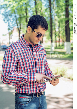 The man in the summer in the park, reading glasses The man in the summer in the park, reading glasses 29329625