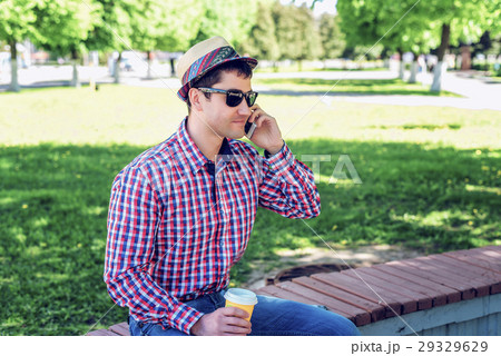 man in  shirt and jeans  glasses, talking on t 29329629