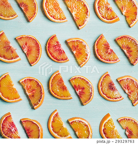 Fresh juicy blood orange slices over blue Fresh juicy blood orange slices over blue 29329763