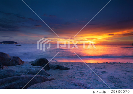 Colorful sunset over ocean on beach 29330070
