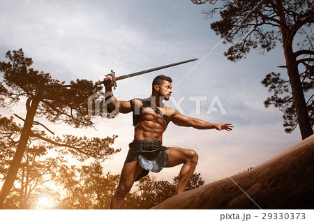 Young muscular warrior with a sword at the 29330373