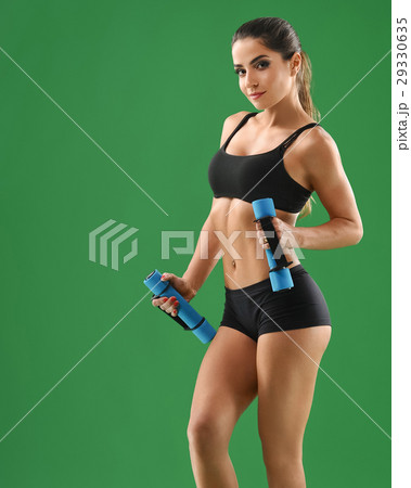 Young attractive woman with dumbbells in her hands 29330635