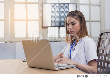 Confident female doctor sitting at office desk, health care and 29335236