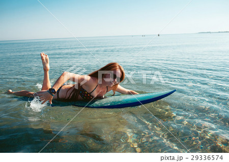 Beautiful sexy surfer girl on the beach 29336574