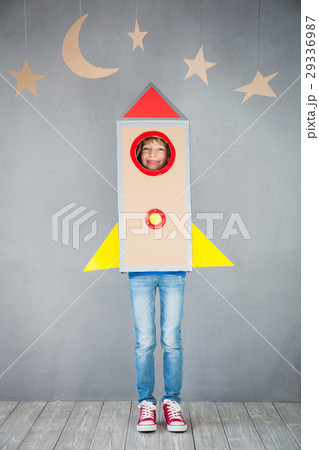 Kid playing with cardboard rocket at home 29336987