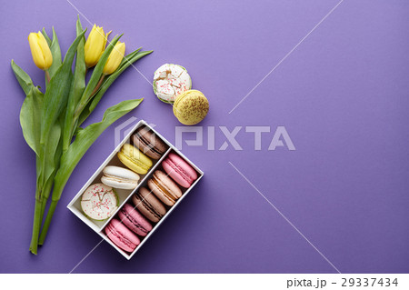 Yellow tulips and a box of macarons 29337434