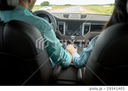 happy couple driving in car and holding hands 29341403