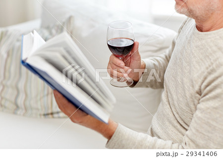 close up of senior man with wine reading book close up of senior man with wine reading book 29341406