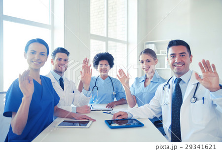 happy doctors meeting and waving hands at hospital happy doctors meeting and waving hands at hospital 29341621