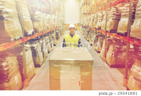 smiling man in hardhat loading cargo at warehouse smiling man in hardhat loading cargo at warehouse 29341691