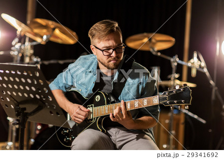 man playing guitar at studio rehearsal man playing guitar at studio rehearsal 29341692