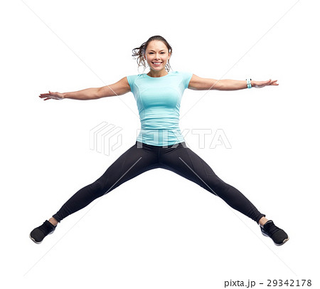 happy smiling sporty young woman jumping in air happy smiling sporty young woman jumping in air 29342178