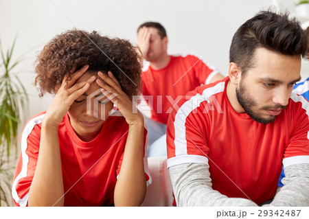 sad friends or football fans at home 29342487