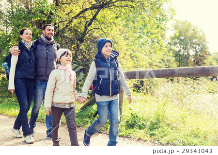 happy family with backpacks hiking in woods happy family with backpacks hiking in woods 29343043