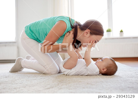 happy mother playing with baby at home 29343129