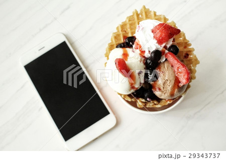 Ice cream with berry and smart phone Ice cream with berry and smart phone 29343737