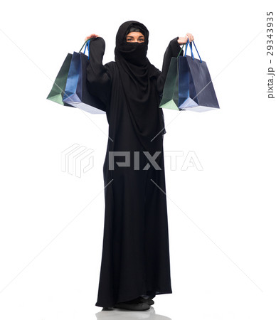 muslim woman in hijab with shopping bags muslim woman in hijab with shopping bags 29343935