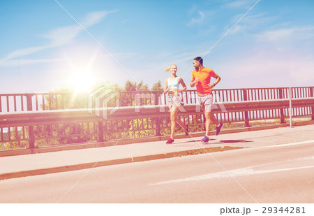smiling couple running at summer seaside smiling couple running at summer seaside 29344281