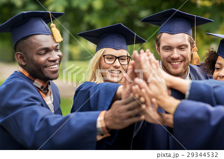 happy students in mortar boards making high five 29344532