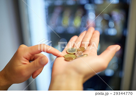 hands counting euro coins at vending machine hands counting euro coins at vending machine 29344770