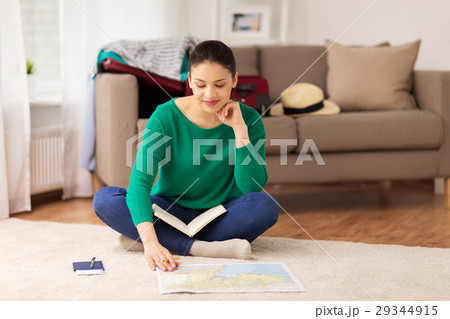 woman with notebook and travel map at home woman with notebook and travel map at home 29344915