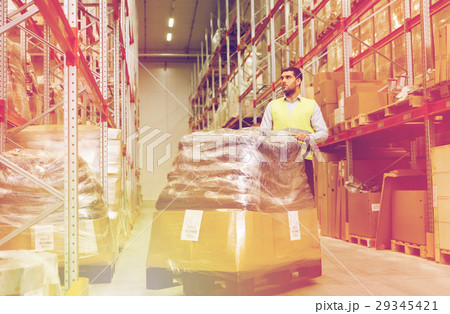 man carrying loader with goods at warehouse 29345421