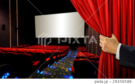 Cinema seats with hand opening red curtain 29350586