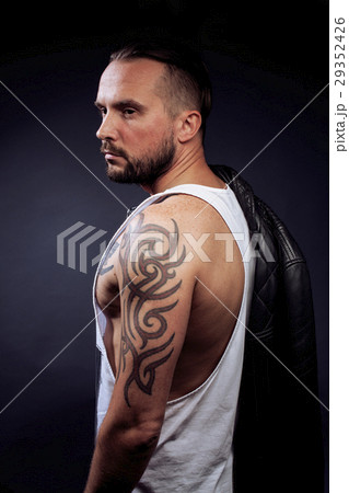 A man with tattooes on his arms. Silhouette of A man with tattooes on his arms. Silhouette of 29352426
