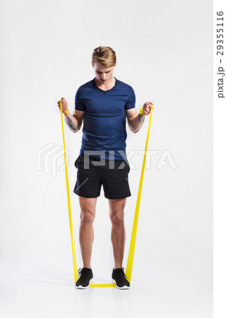 Fitness man working out with resistance bands Fitness man working out with resistance bands 29355116