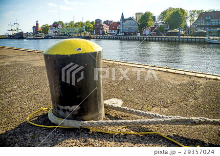 bollard in a seaport with sailing ship bollard in a seaport with sailing ship 29357024