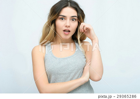 Young girl with long curly hair posing on blue Young girl with long curly hair posing on blue 29365286
