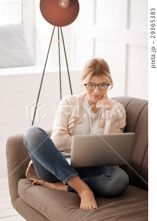 Delighted positive woman watching a film 29365385