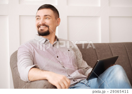 Positive joyful man resting at home 29365411