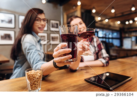 Close up of female hands with glasses of juice 29366104